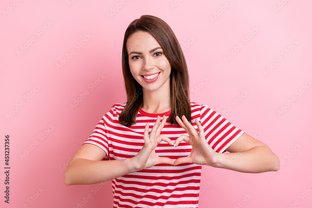 Photo of young girl happy positive smile show fingers heart symbol valentine day love isolated over pink color background Photo of young girl happy positive smile show fingers heart symbol valentine day love isolated over pink color background
