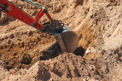 Excavator shovel digging on dirt