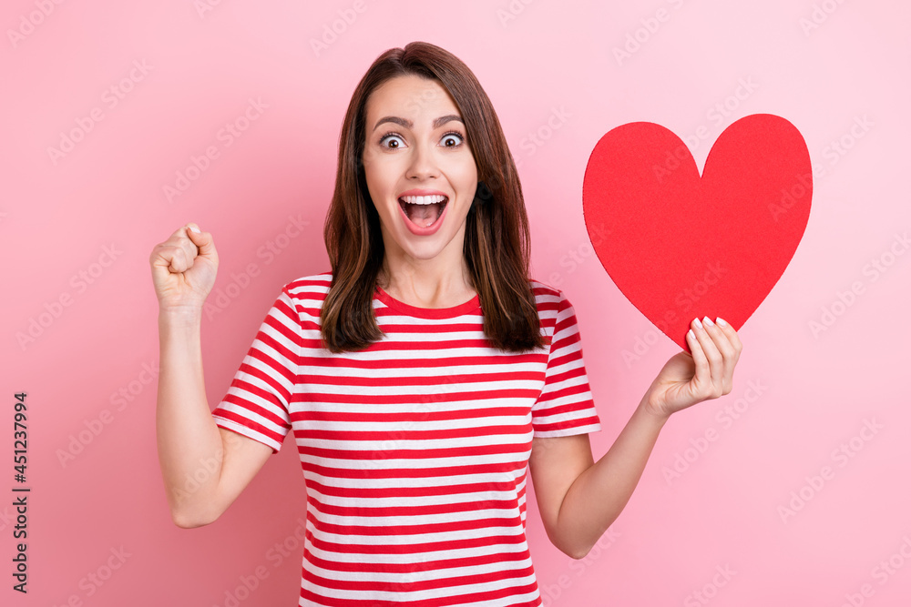 Photo of young excited girl happy smile hold paper heart figure feelings romantic celebrate isolated over pink color background Photo of young excited girl happy smile hold paper heart figure feelings romantic celebrate isolated over pink color background