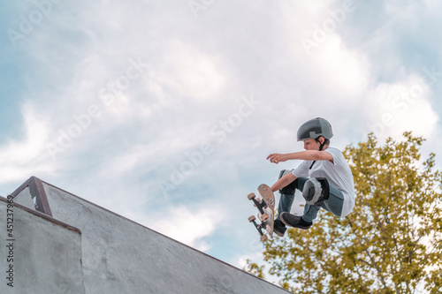 Skater performing trick on ramp in skate park
