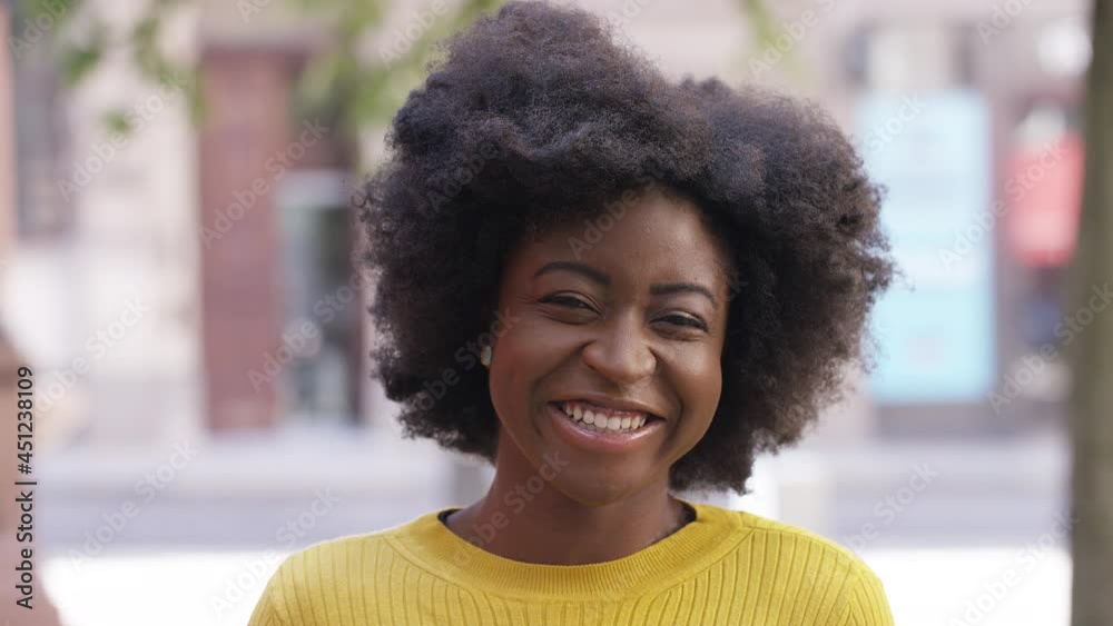 Beautiful young black female laughing as she reacts to something, in slow motion Beautiful young black female laughing as she reacts to something, in slow motion