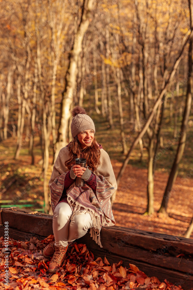 Woman drinking coffee while spending sunny autumn day outdoors Woman drinking coffee while spending sunny autumn day outdoors