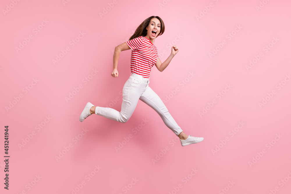 Full length profile side photo of young girl happy positive smile hurry fast sale go runner isolated over pink color background Full length profile side photo of young girl happy positive smile hurry fast sale go runner isolated over pink color background