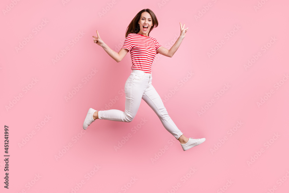 Full length profile side photo of young girl happy positive smile jump up show peace cool v-sign isolated over pastel color background