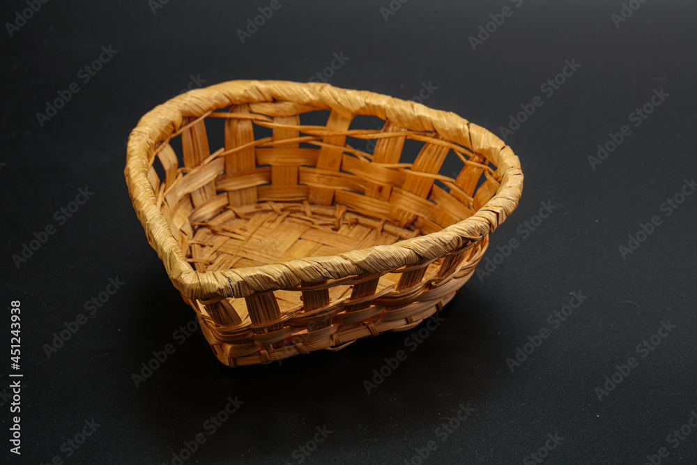 Natural wicker tableware for serving over black Natural wicker tableware for serving over black