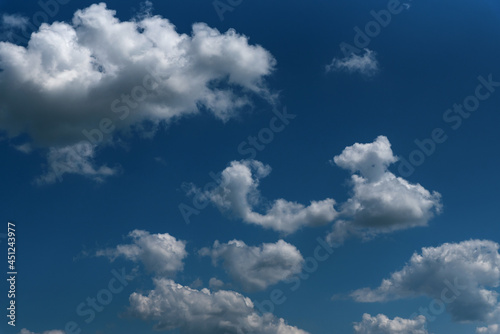 Fototapeta Naklejka Na Ścianę i Meble -  Dark blue sky and white clouds natural background. White cumulus clouds in the blue sky.