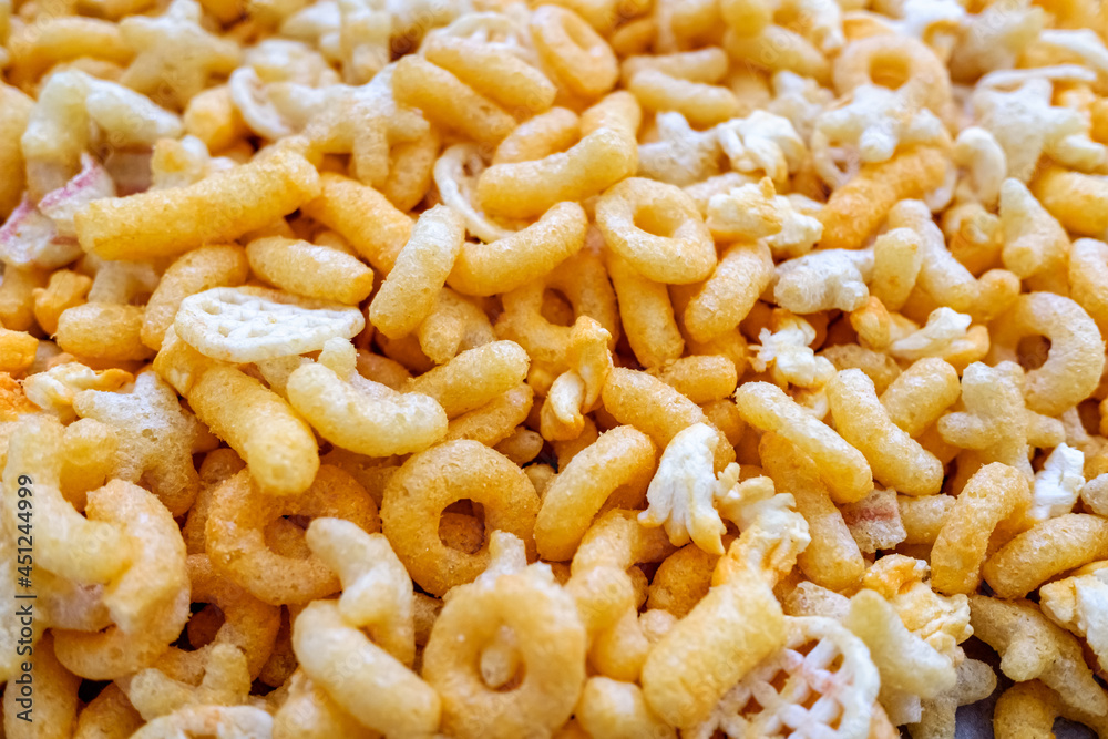 Detail of a snack based on flavored cheese puff, with corn flour and hydrogenated fats. Detail of a snack based on flavored cheese puff, with corn flour and hydrogenated fats.
