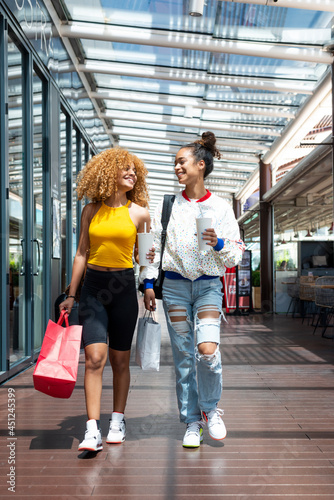 Delighted black women during shopping in mall photo