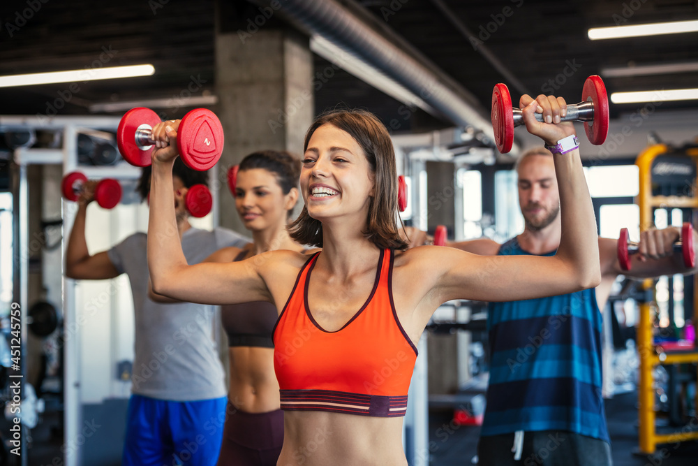Group of fit people at the gym exercising Group of fit people at the gym exercising