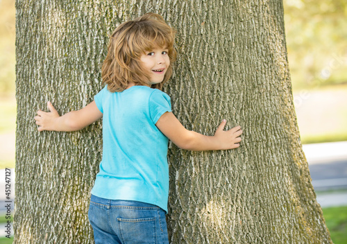 Its so wide. Boy child try to climb tree. Childhood and boyhood. Boyhood days. Tree climbing