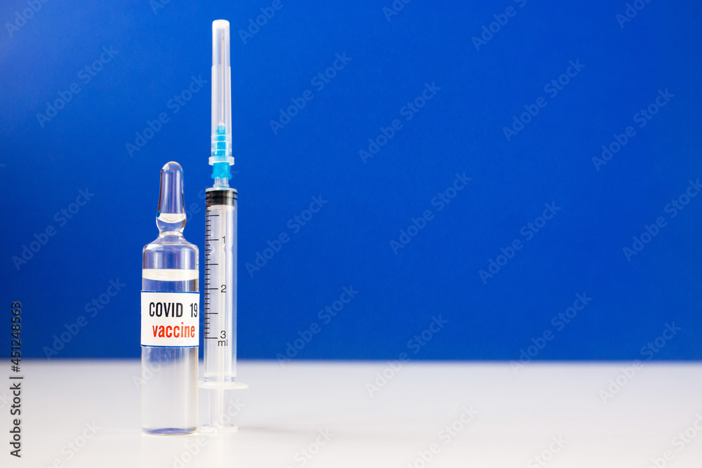 Vaccination Covid 19 topic. Close up of ampoule with vaccine and syringe. Coronavirus vaccine, global pandemic. Selective focus, shallow depth of field. Copy space Vaccination Covid 19 topic. Close up of ampoule with vaccine and syringe. Coronavirus vaccine, global pandemic. Selective focus, shallow depth of field. Copy space