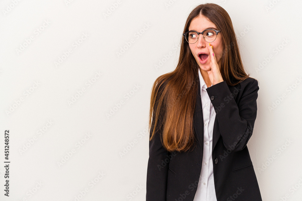 Young caucasian business woman isolated on white background is saying a secret hot braking news and looking aside Young caucasian business woman isolated on white background is saying a secret hot braking news and looking aside