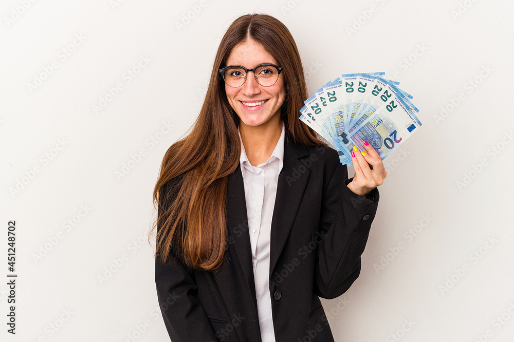 Young caucasian business woman holding banknotes isolated on white background happy, smiling and cheerful. Young caucasian business woman holding banknotes isolated on white background happy, smiling and cheerful.