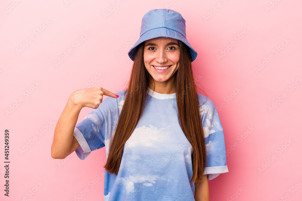 Young caucasian woman isolated on pink background person pointing by hand to a shirt copy space, proud and confident Young caucasian woman isolated on pink background person pointing by hand to a shirt copy space, proud and confident