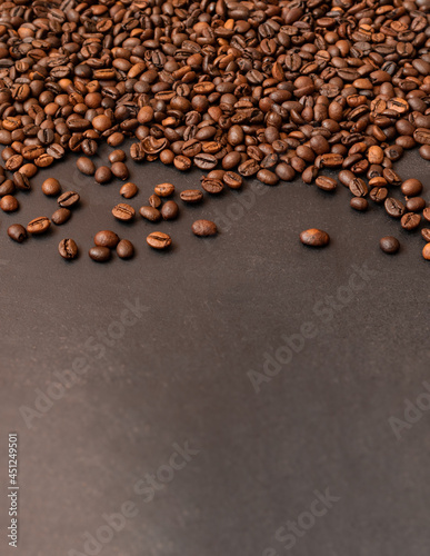 Fresh roasted coffee beans on dark background. Selective focus.