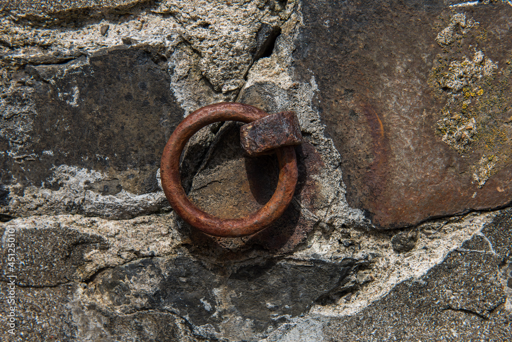 Old Rusted iron ring embedded in harbor wall