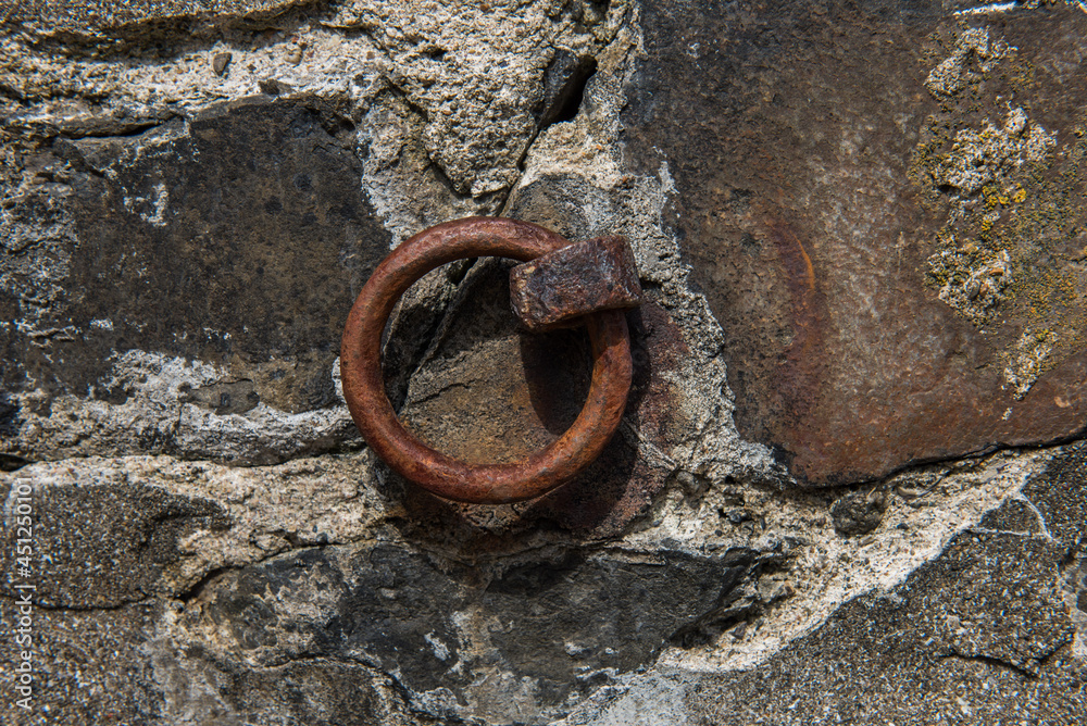 Old Rusted iron ring embedded in harbor wall Old Rusted iron ring embedded in harbor wall