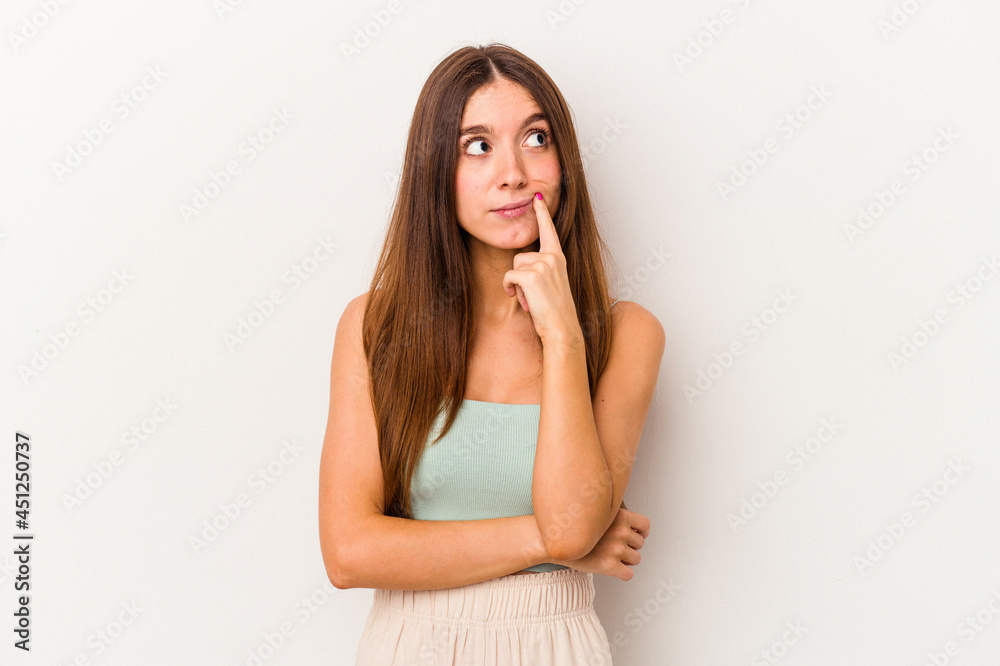 Young caucasian woman isolated on white background looking sideways with doubtful and skeptical expression. Young caucasian woman isolated on white background looking sideways with doubtful and skeptical expression.