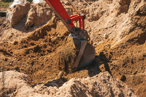 Excavator shovel digging on dirt