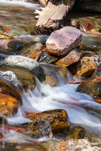 Water rushing over colorful rocks 