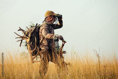 Archery hunter scouting for his next target. photo