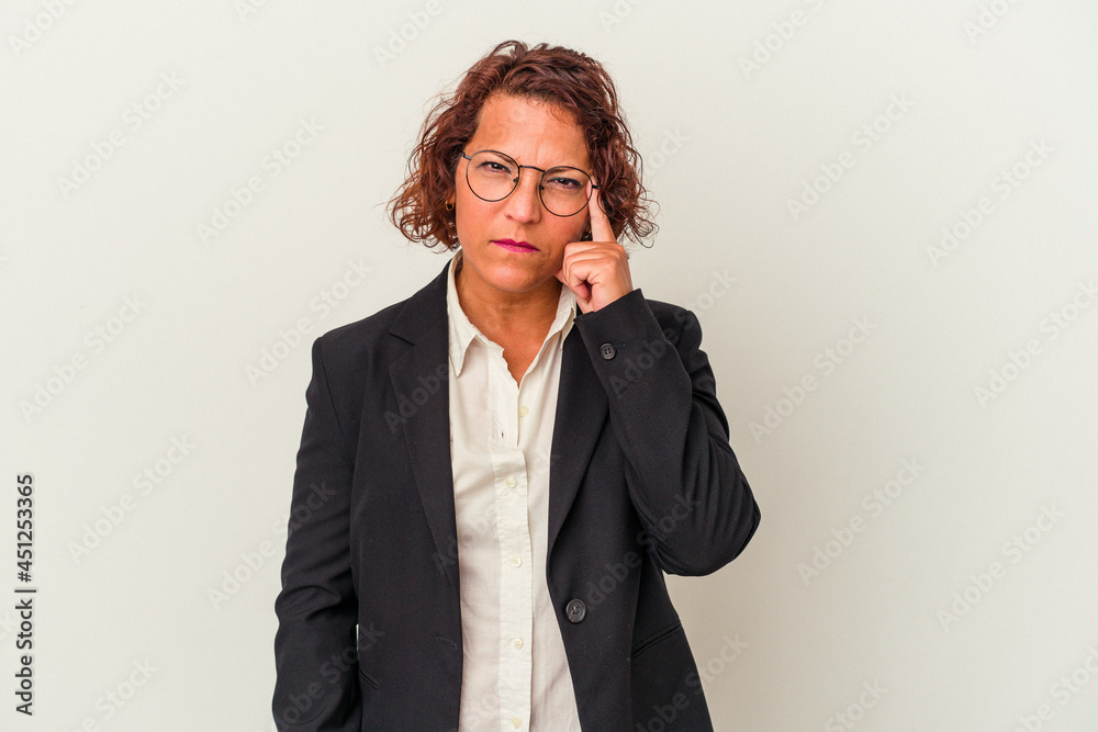 Middle age latin business woman isolated on white background pointing temple with finger, thinking, focused on a task. Middle age latin business woman isolated on white background pointing temple with finger, thinking, focused on a task.