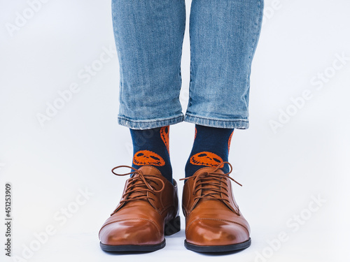 Men's legs, trendy shoes and bright socks. Close-up. Style, beauty and elegance concept