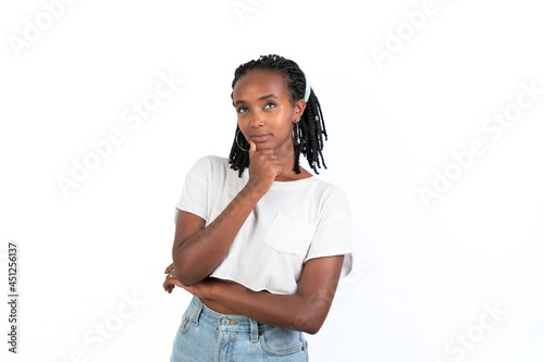 Beautiful woman thinking with her hand in the chin. White background. African-Ethiopian black woman. Thoughtful concept. photo