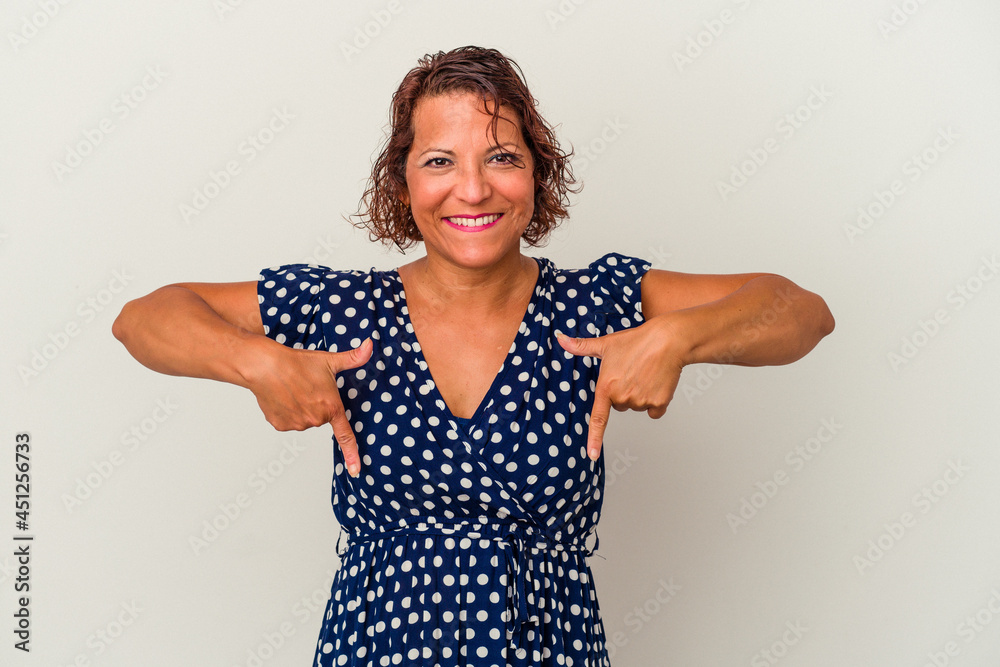 Middle age latin woman isolated on white background points down with fingers, positive feeling. Middle age latin woman isolated on white background points down with fingers, positive feeling.