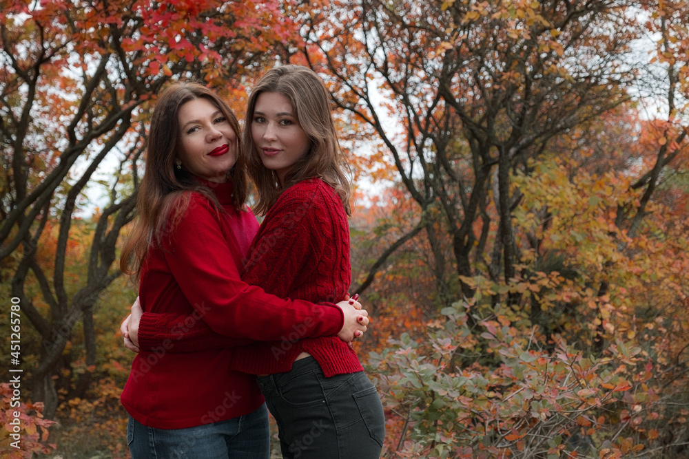 Mature mother hugging with her teen daughter outdoor in nature Mature mother hugging with her teen daughter outdoor in nature