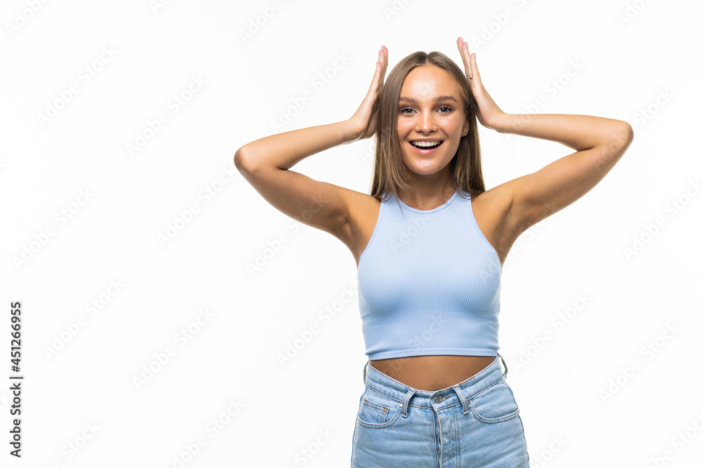 Beautiful happy blond girl touches her hair on the White background. Beautiful happy blond girl touches her hair on the White background.