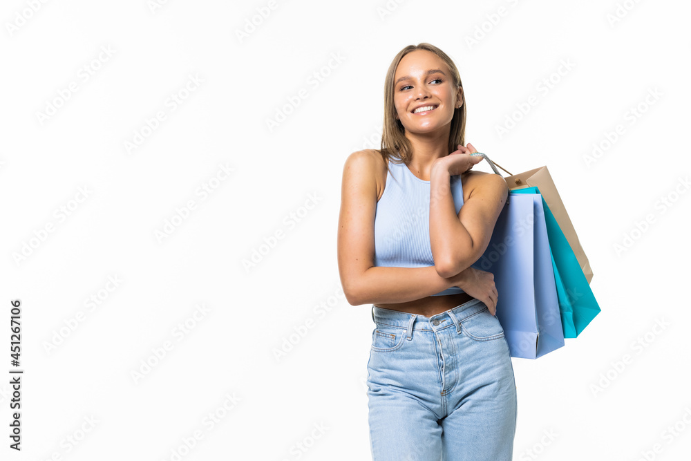 Portrait of young happy woman with shopping bags, isolated over white background