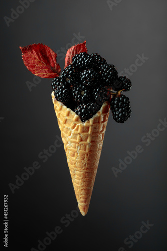Fresh blackberries in a waffle cone.