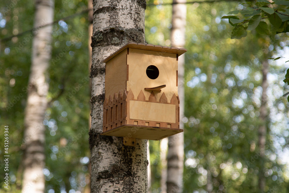 a birdhouse on the street in the park.A bird house. a birdhouse on the street in the park.A bird house.