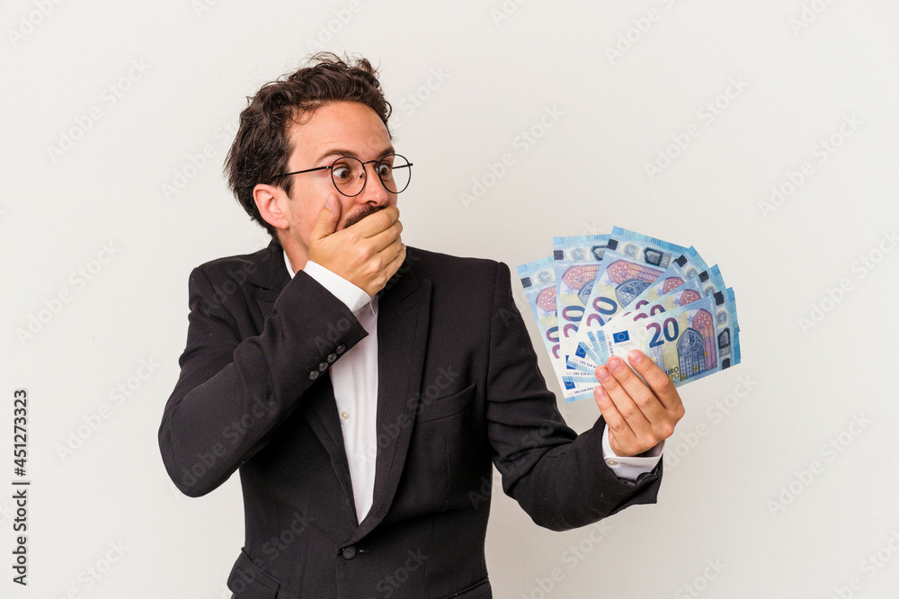 Young caucasian man holding banknotes isolated on pink background Young caucasian man holding banknotes isolated on pink background
