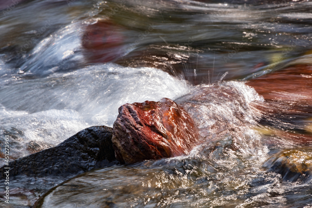 Water rushing over colorful rocks
Water rushing over colorful rocks