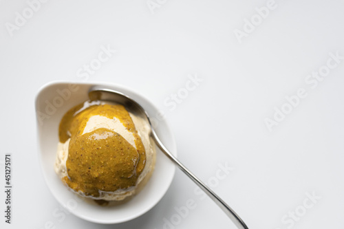 homemade pistachio ice cream with maple syrup, with pistachio sauce on top, gluten-free and sugerfree. Without colouring and artificial flavors!