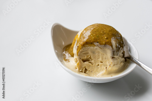 homemade pistachio ice cream with maple syrup, with pistachio sauce on top, gluten-free and sugerfree. Without colouring and artificial flavors! photo