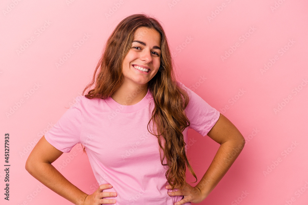 Young caucasian woman isolated on pink background confident keeping hands on hips. Young caucasian woman isolated on pink background confident keeping hands on hips.