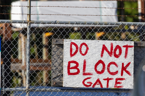 red do not block gate sign on gate