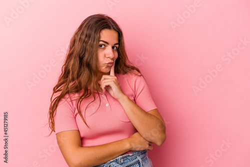 Young caucasian woman isolated on pink background  contemplating  planning a strategy  thinking about the way of a business.