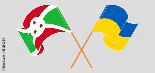 Crossed and waving flags of Burundi and Ukraine