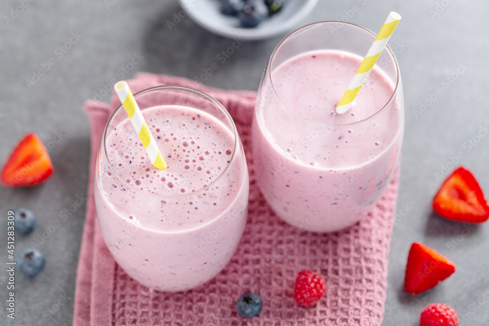 Fresh milkshake with berries in glasses Fresh milkshake with berries in glasses