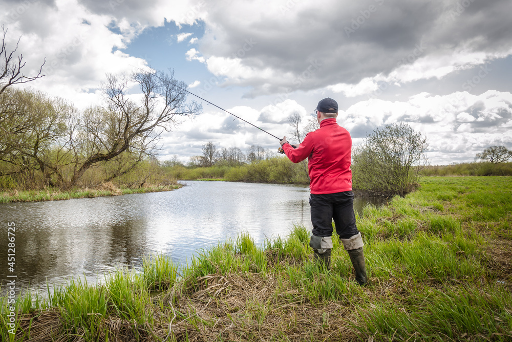 Fisherman in red clothes is fishing. Fisherman in red clothes is fishing.