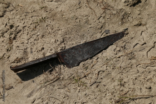 Medieval rusty knife on the sand