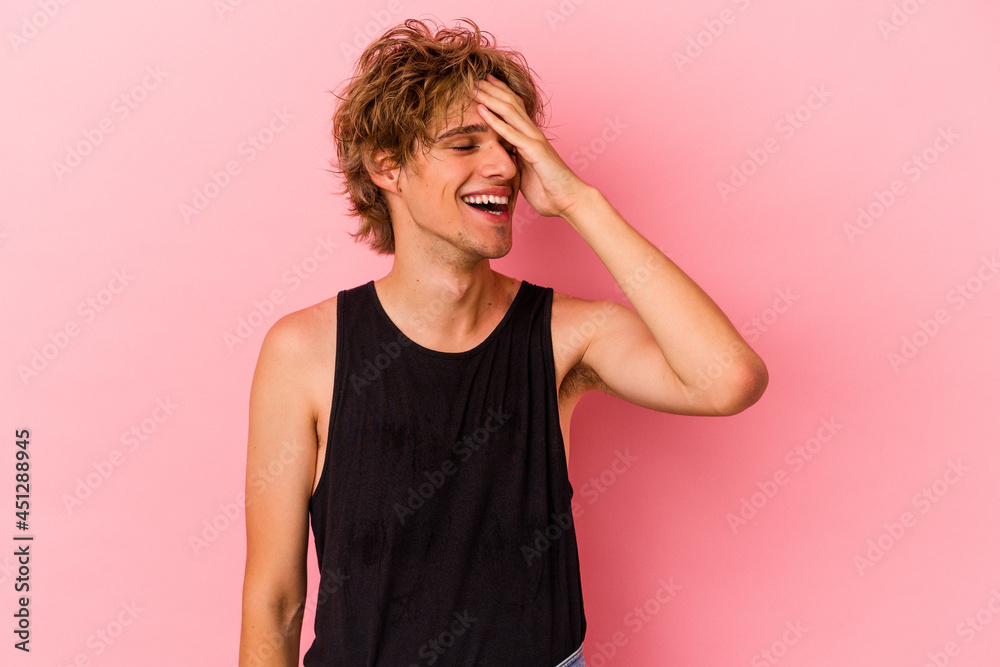 Young caucasian man with make up isolated on pink background laughing happy, carefree, natural emotion. Young caucasian man with make up isolated on pink background laughing happy, carefree, natural emotion.