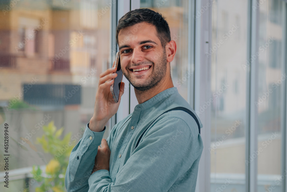 smiling businessman with mobile phone in office smiling businessman with mobile phone in office
