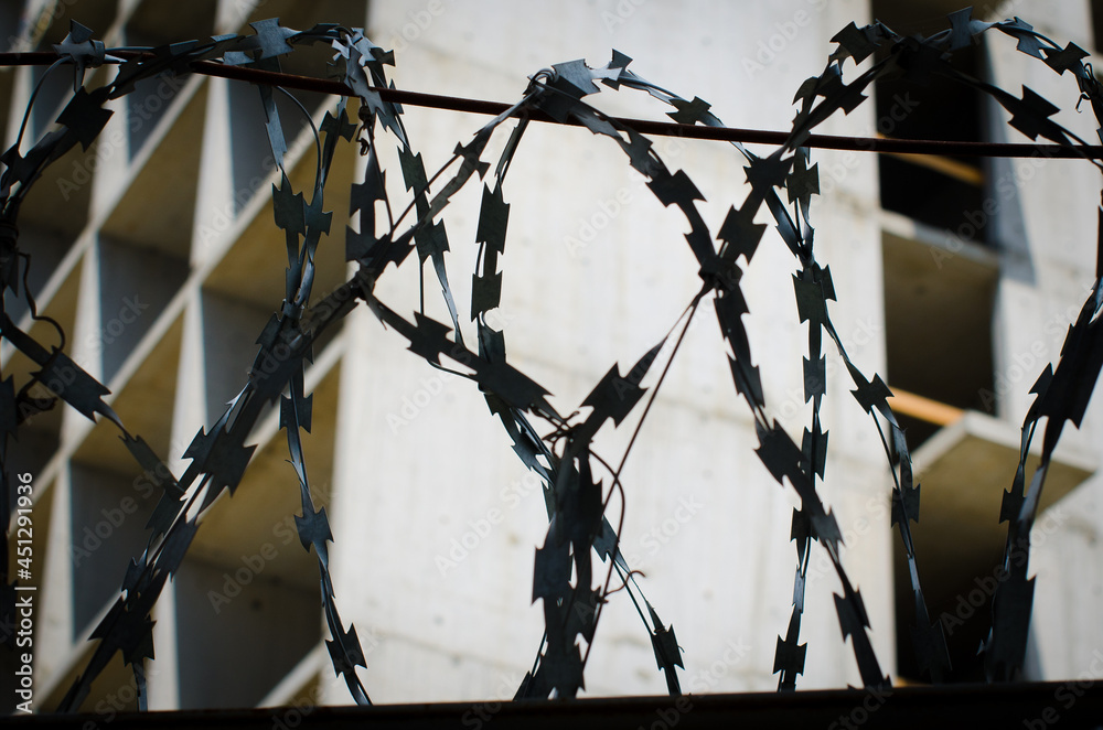 barbed wire fence of a construction site barbed wire fence of a construction site
