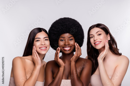 Photo of three young attractive woman happy positive smile apply cream facial perfect isolated over grey color background