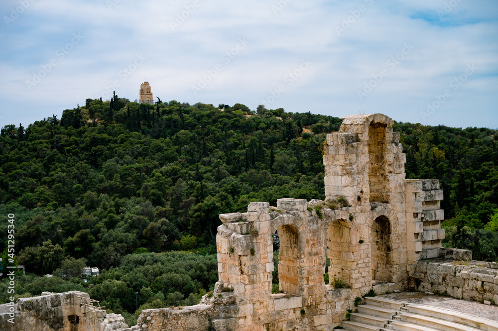 Close-up of remains of wall of The Odeon of Herodes Atticus in Athens. Cityscape of Athens at cloudy day. Acropolis hill. Close-up of remains of wall of The Odeon of Herodes Atticus in Athens. Cityscape of Athens at cloudy day. Acropolis hill.